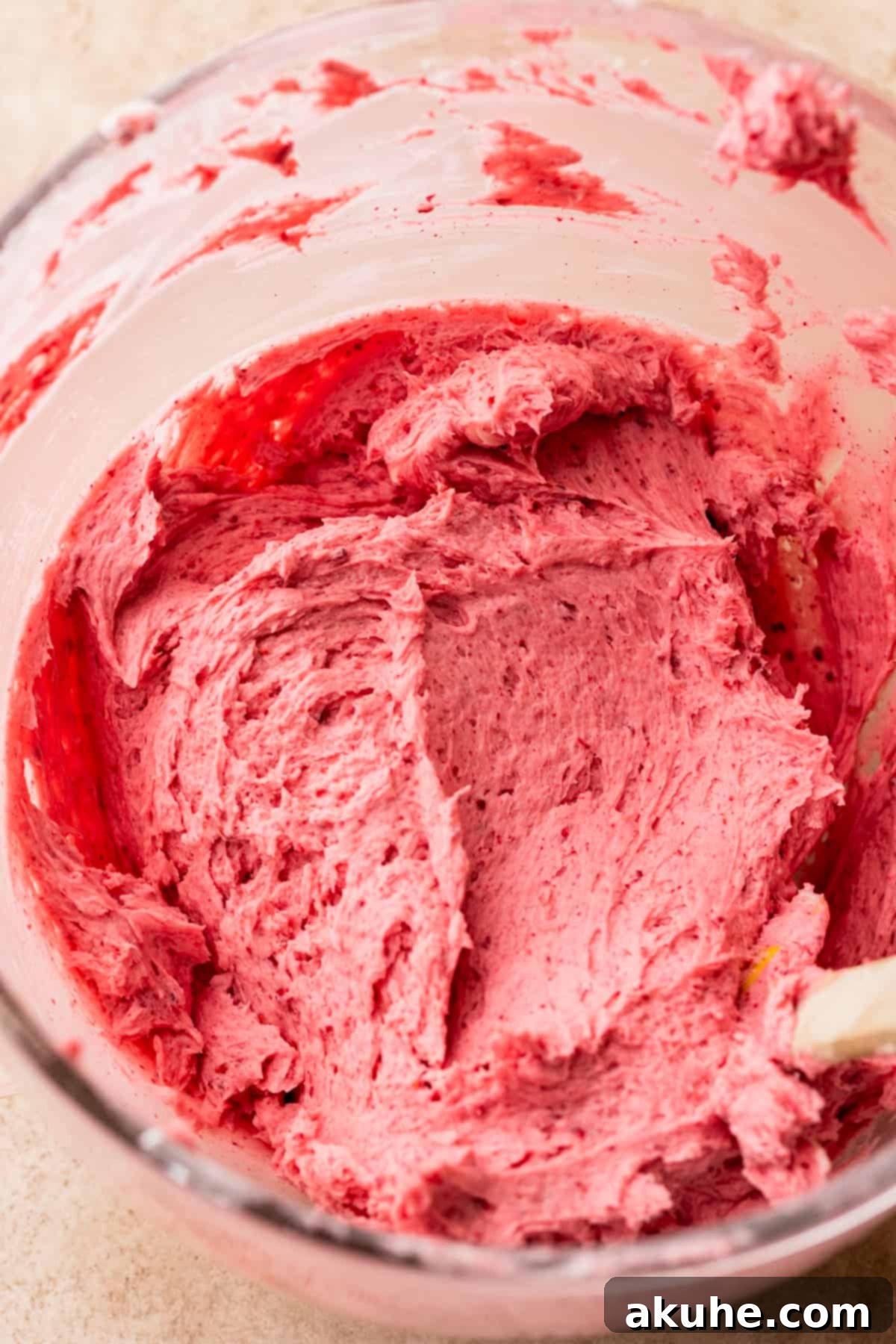 Decadent Chocolate Raspberry Delight 7 Raspberry frosting in a glass bowl.