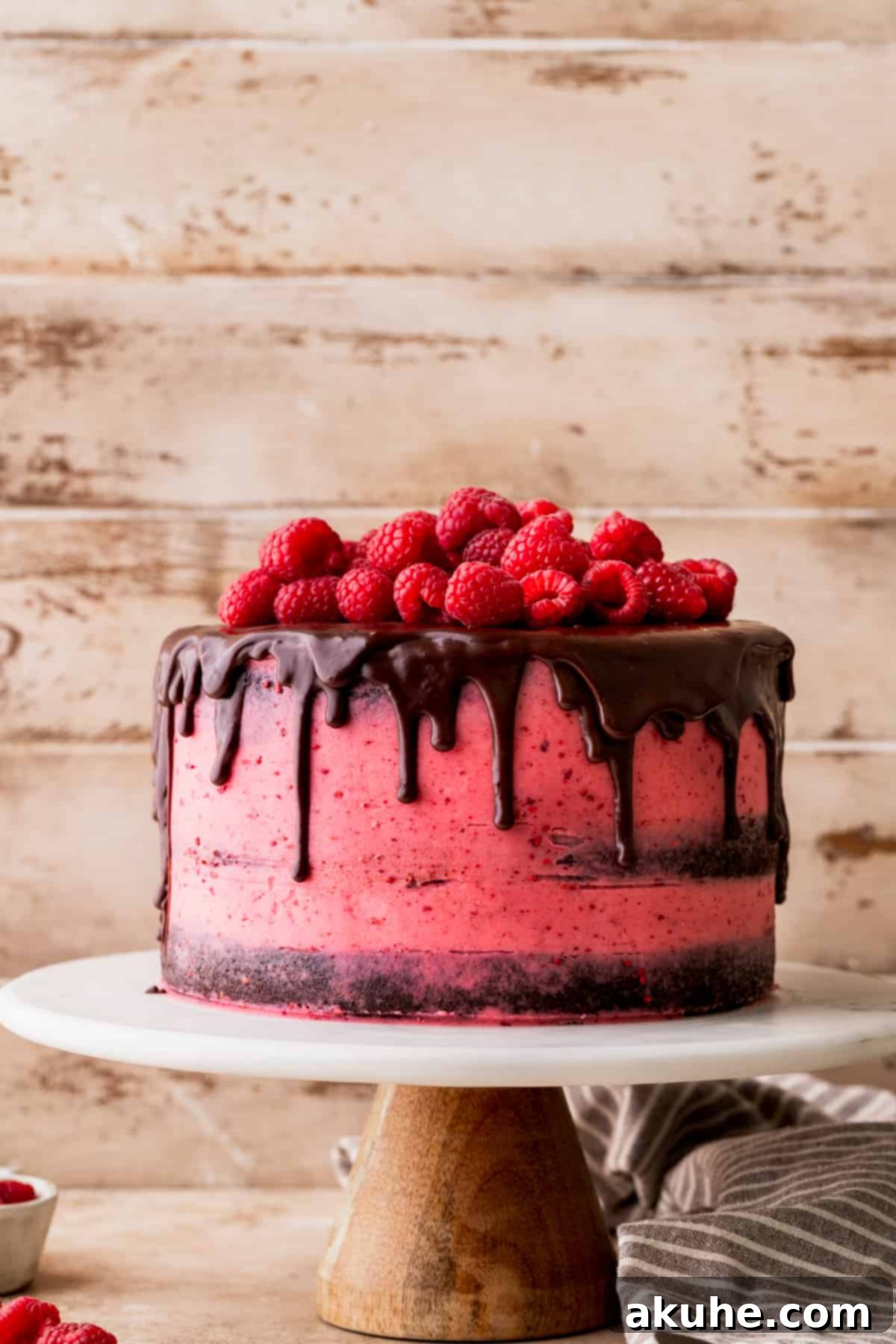 Decadent Chocolate Raspberry Delight 9 Decorated cake on a cake stand.