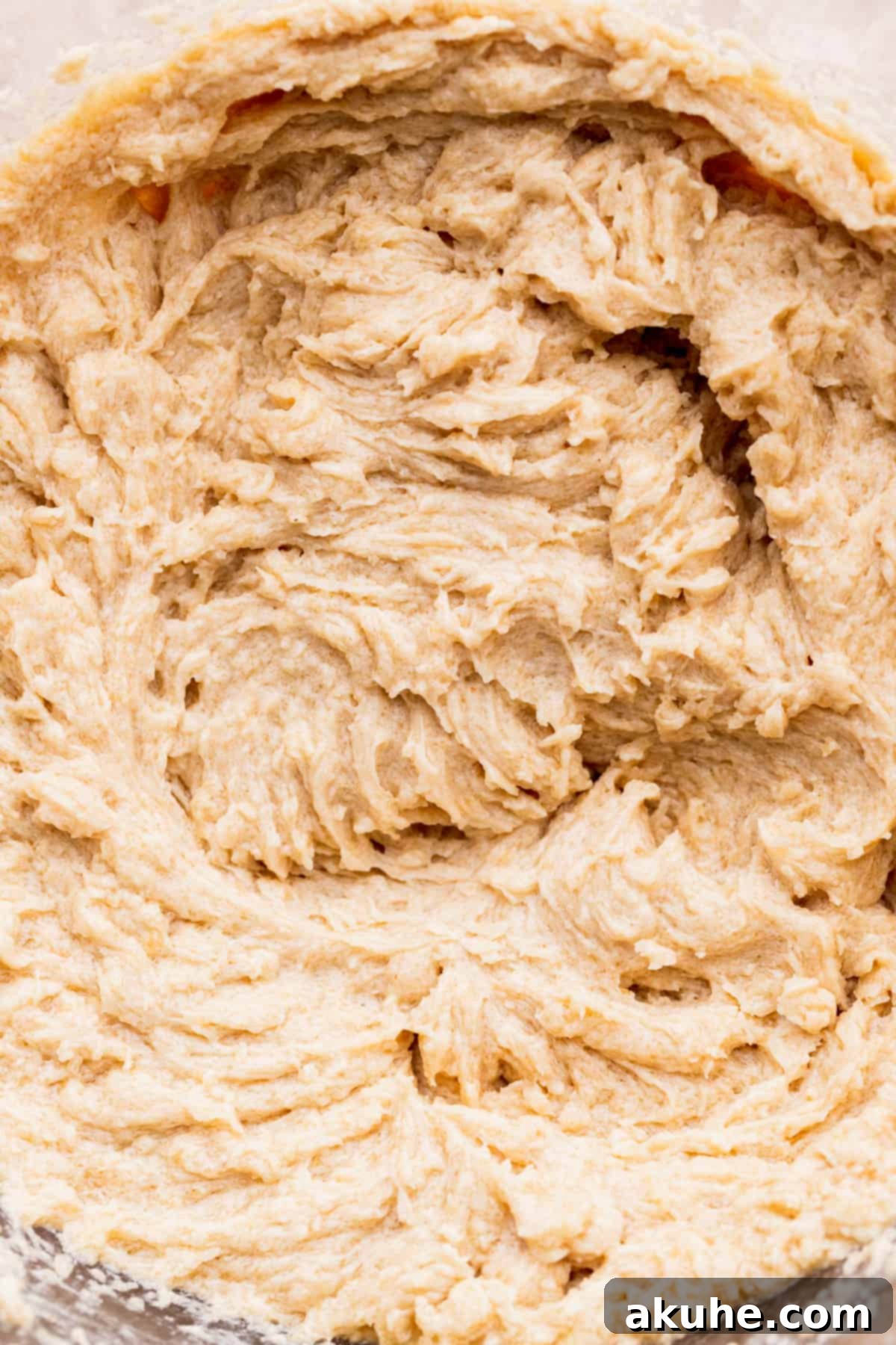 Irresistible Eggless Chocolate Chip Cookies 5 Wet ingredients (butter, sugars, vanilla, applesauce) in a bowl, ready for dry ingredients.