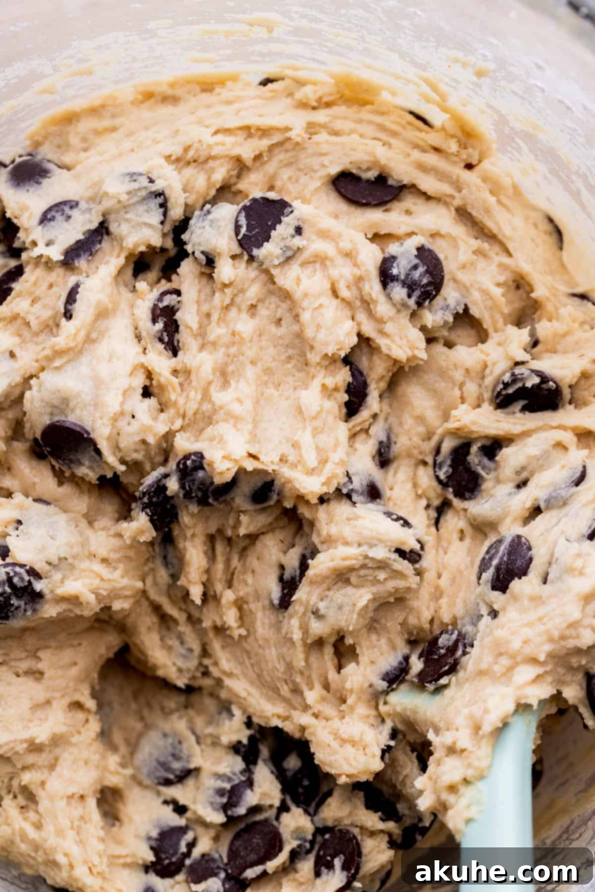 Irresistible Eggless Chocolate Chip Cookies 6 Ready-to-bake cookie dough in a glass bowl, with chocolate chips mixed in.