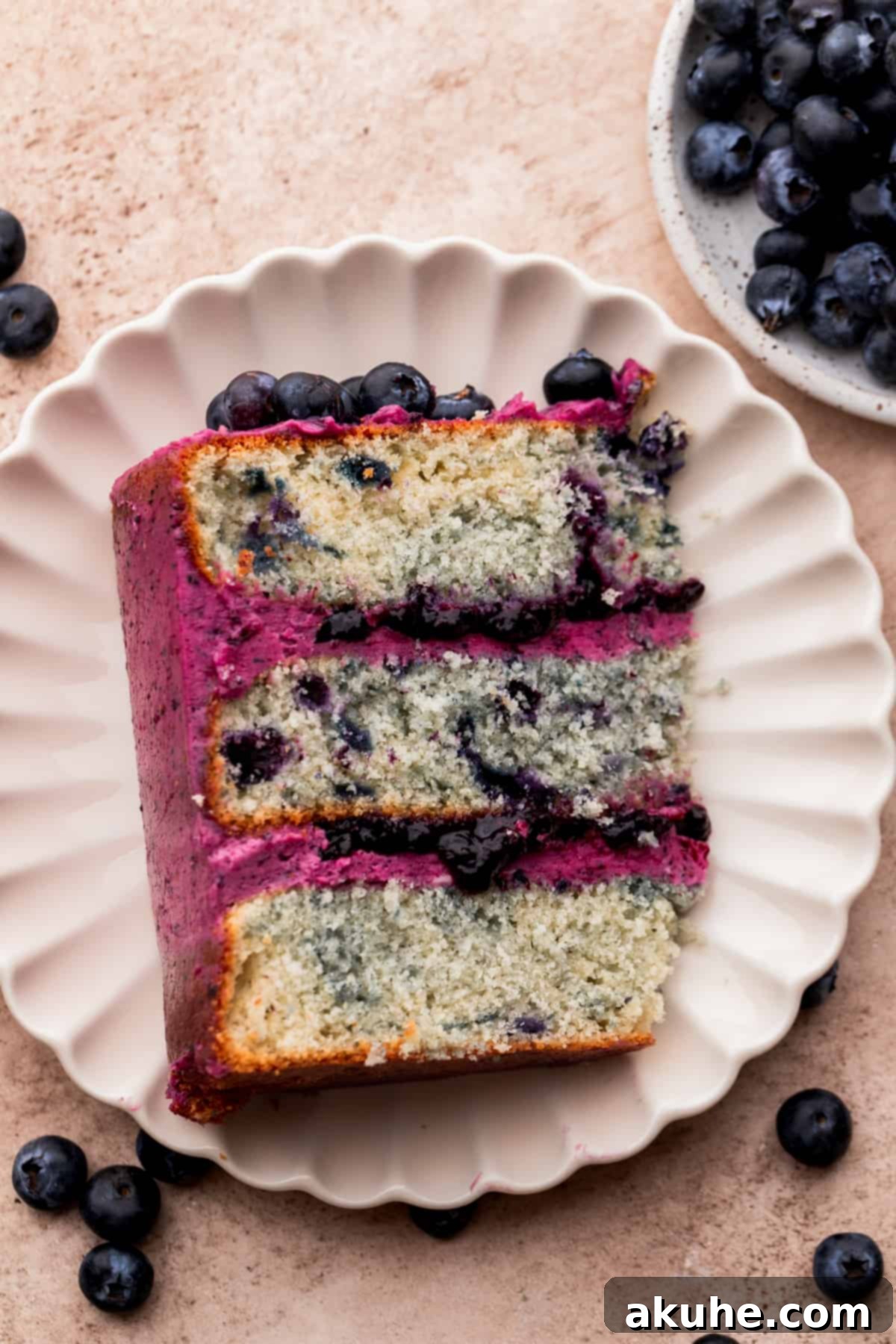 Bursting Berry Bliss 14 An overhead view of a beautifully sliced blueberry cake, highlighting its layers and inviting texture.