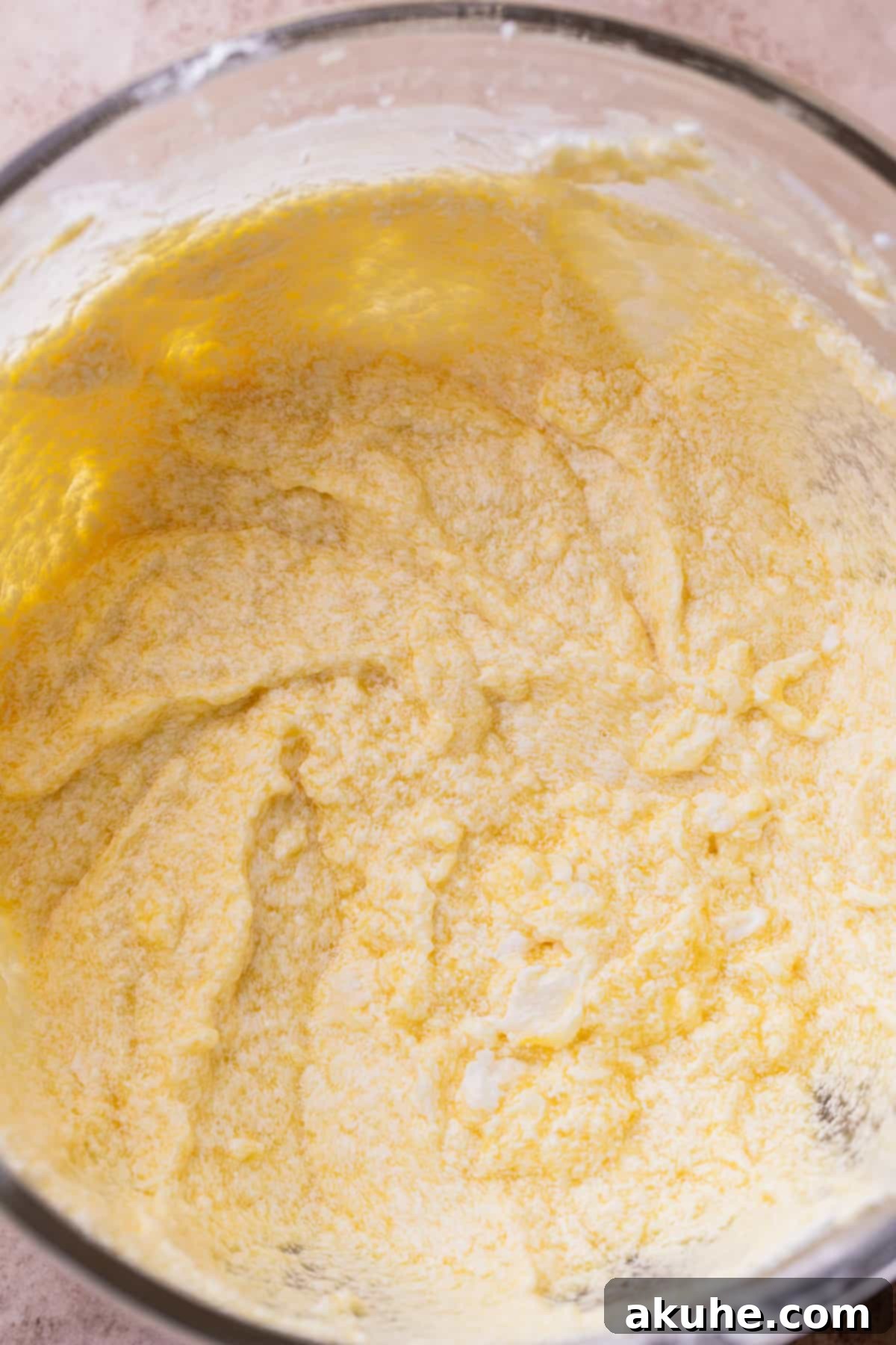 Bursting Berry Bliss 5 Close-up of creamy, light-yellow wet ingredients being mixed in a bowl.