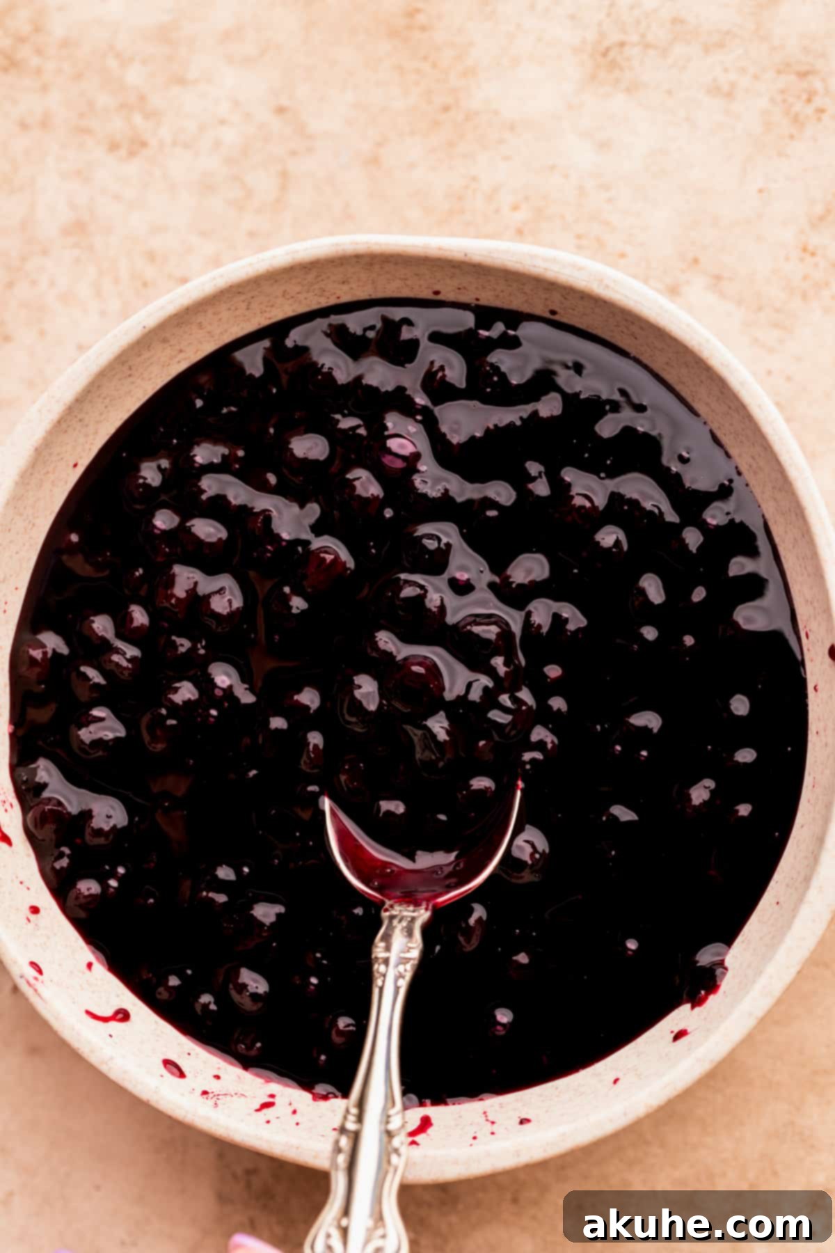 Bursting Berry Bliss 9 Vibrant, homemade blueberry sauce cooling in a small, elegant glass bowl.