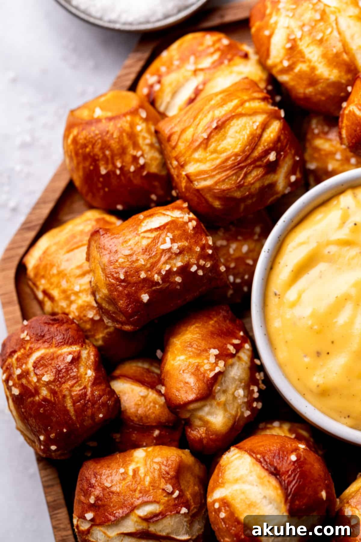 Perfectly Poppable Pretzels 3 Close-up of golden brown pretzel bites on a wooden board.