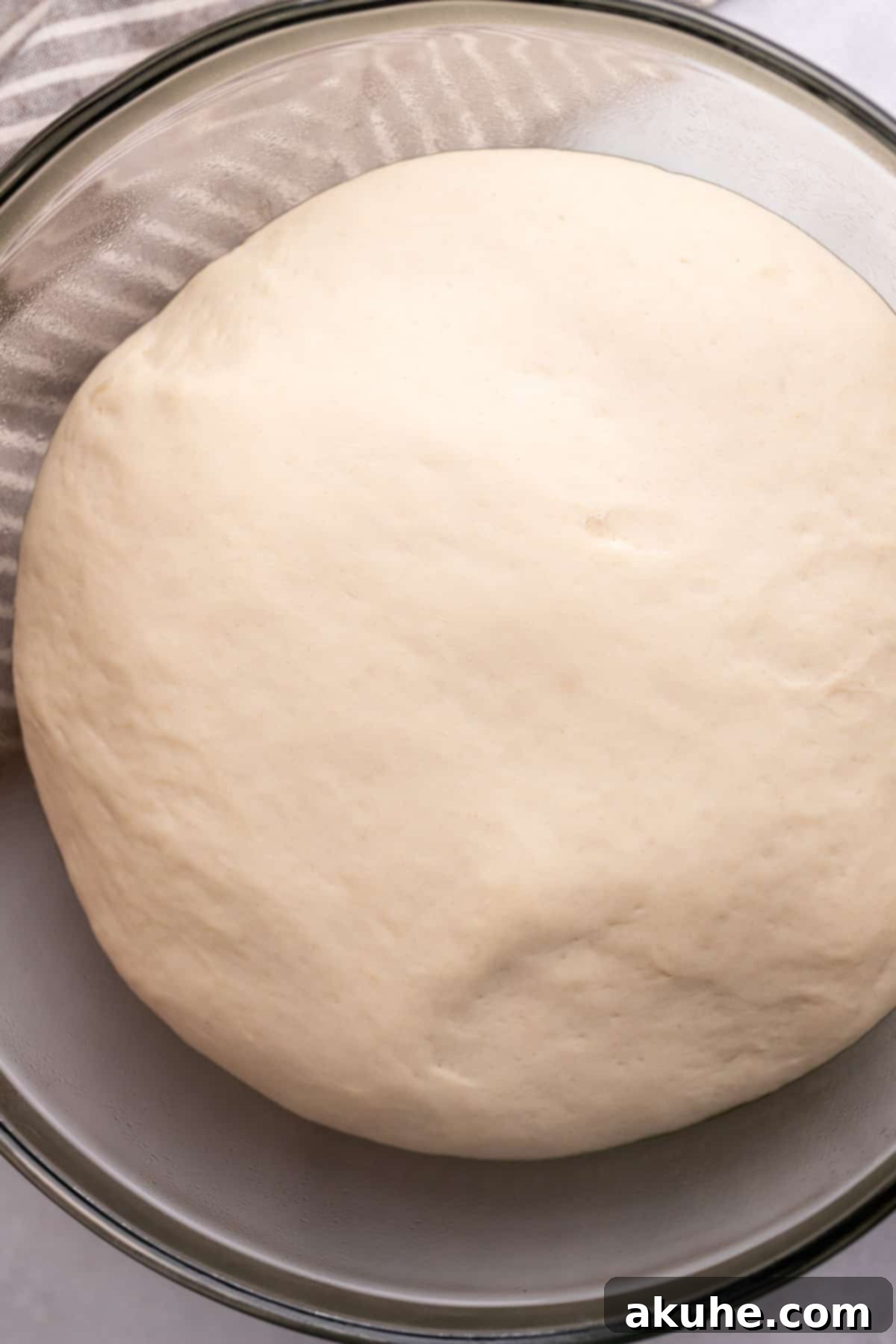 Perfectly Poppable Pretzels 5 Dough in a glass bowl after a successful rise, visibly larger.