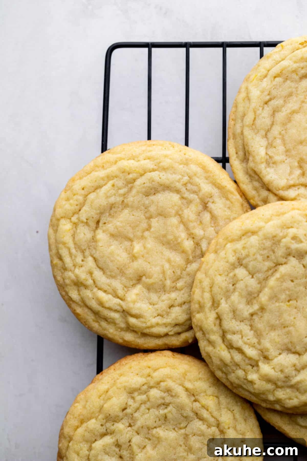 Zesty Lemon Bites 7 Freshly baked lemon cookies cooling on a wire rack.