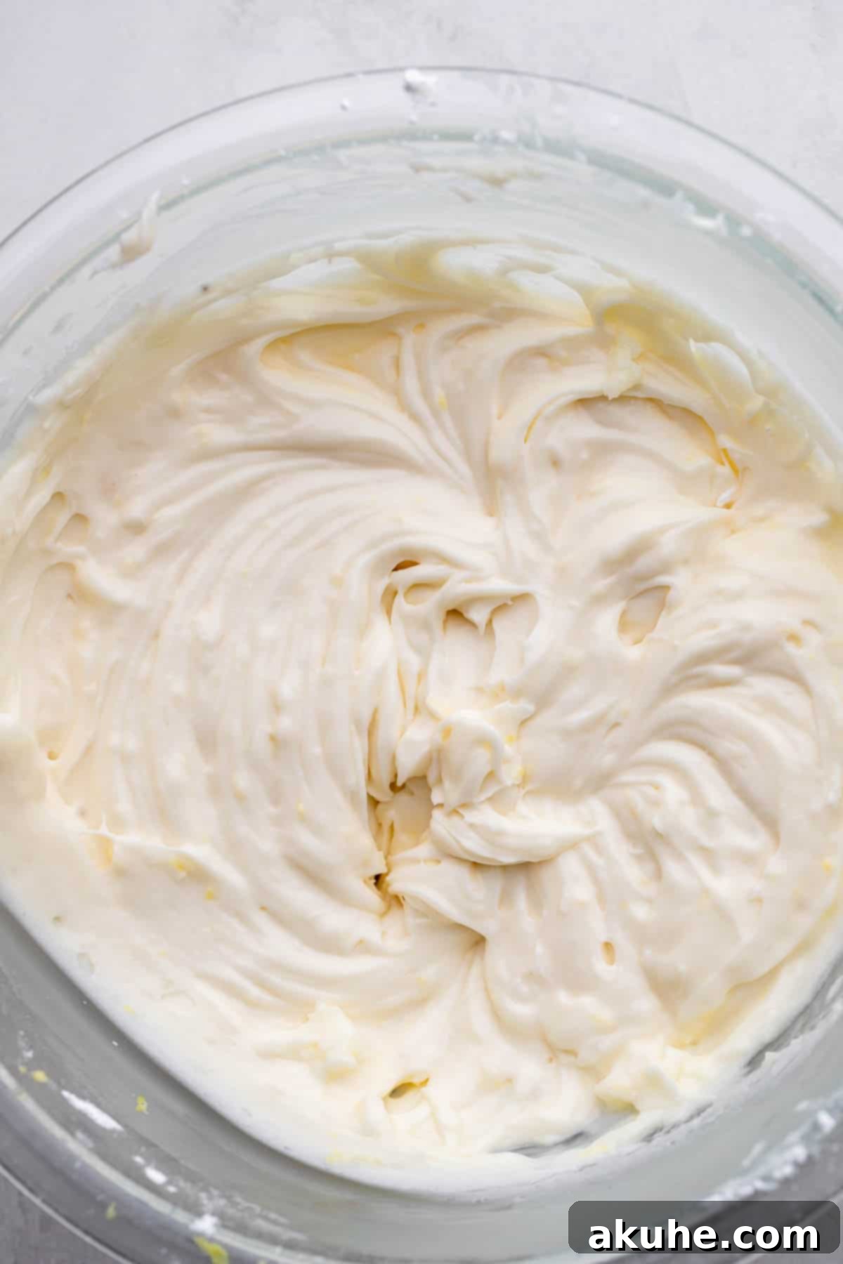 Zesty Lemon Bites 8 Smooth and creamy lemon cream cheese frosting in a glass bowl.