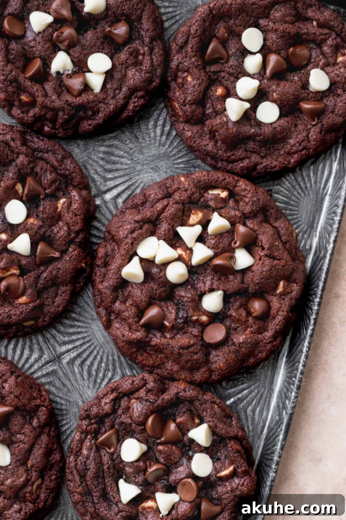 Decadent Double Chocolate White Chip Cookies 2 A tray of freshly baked white chip double chocolate cookies, showcasing their rich, dark color and generous scattering of white and dark chocolate chips.