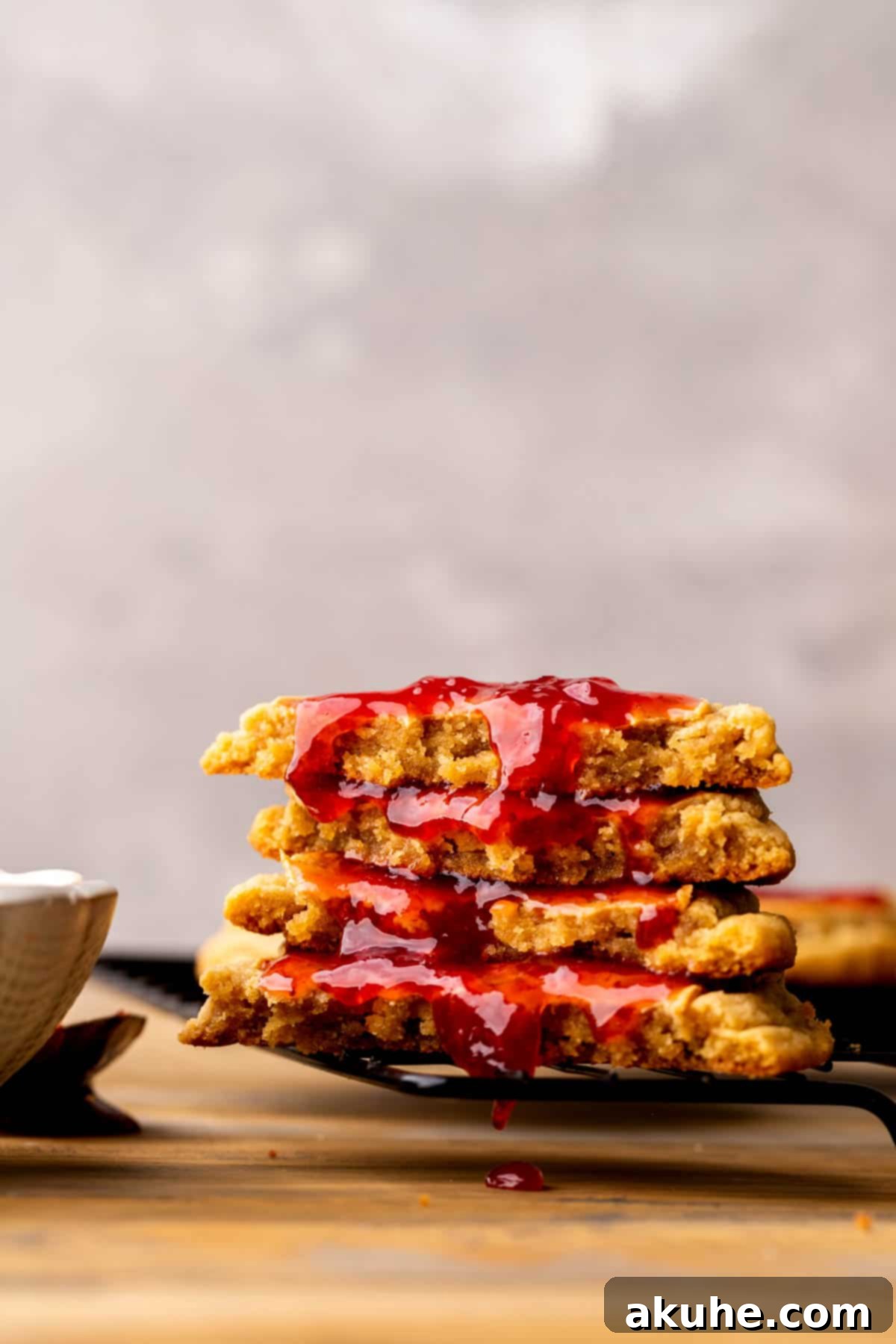 PB&J Cookies 3 Stack of 2 cookies split in half on a wire rack.