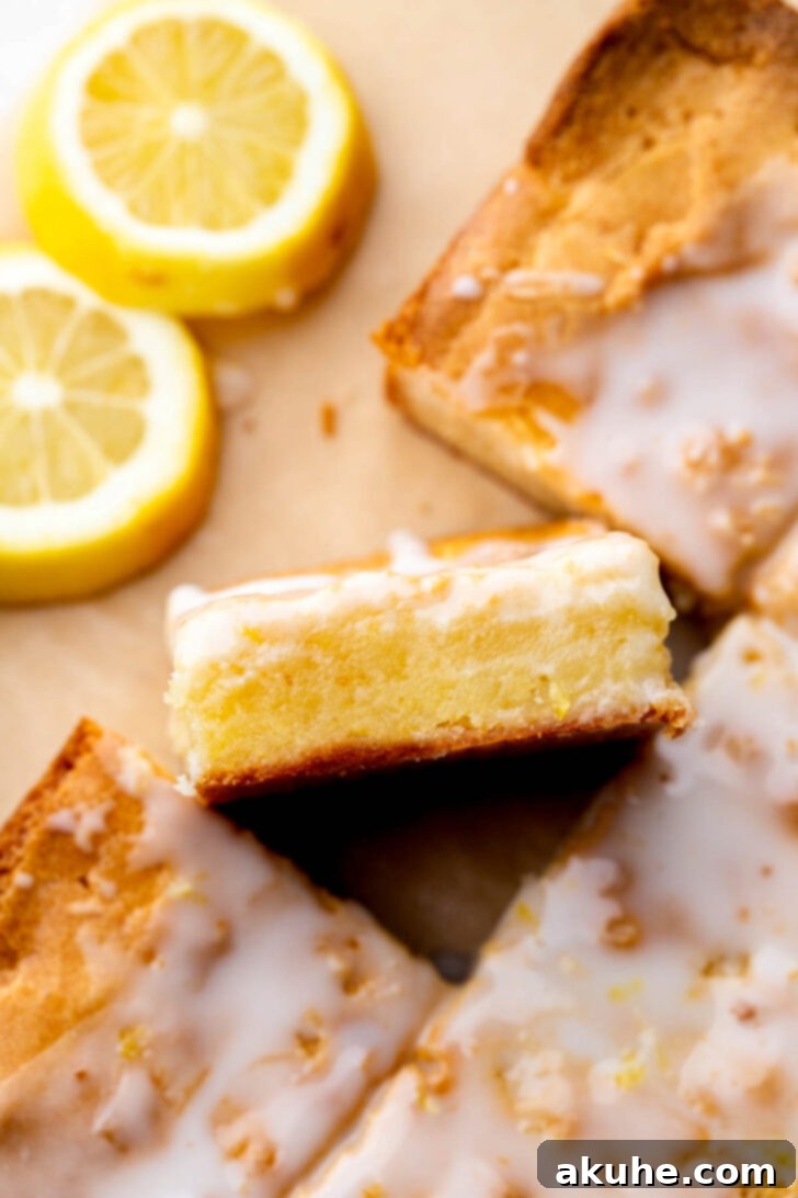 Zesty Lemon Brownies 3 Close-up top view of a single lemon brownie, showing its perfectly glazed surface and soft, moist interior.