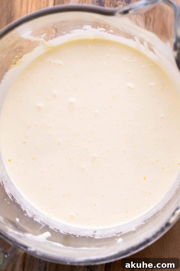 Zesty Lemon Brownies 4 Wet ingredients in a bowl, showing the beaten eggs and sugar mixture.