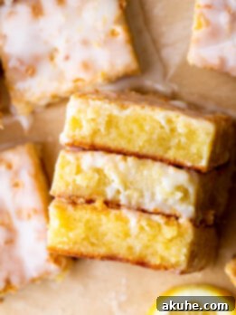 Zesty Lemon Brownies 10 Top view of three lemon brownies with lemon slices.