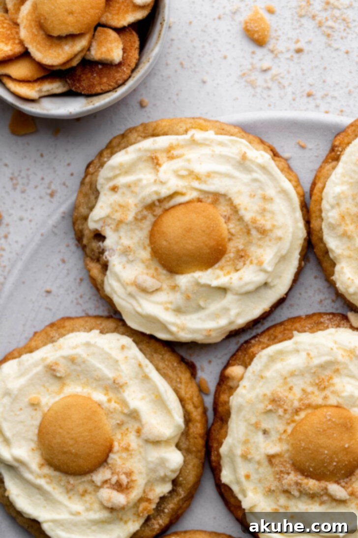 The Ultimate Banana Pudding Cookies 2 Top view of banana pudding cookies, showcasing the whipped topping and Nilla Wafer garnish.