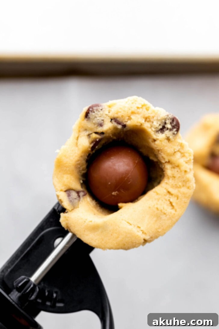 Cookie dough in a scoop with a lindt truffle.