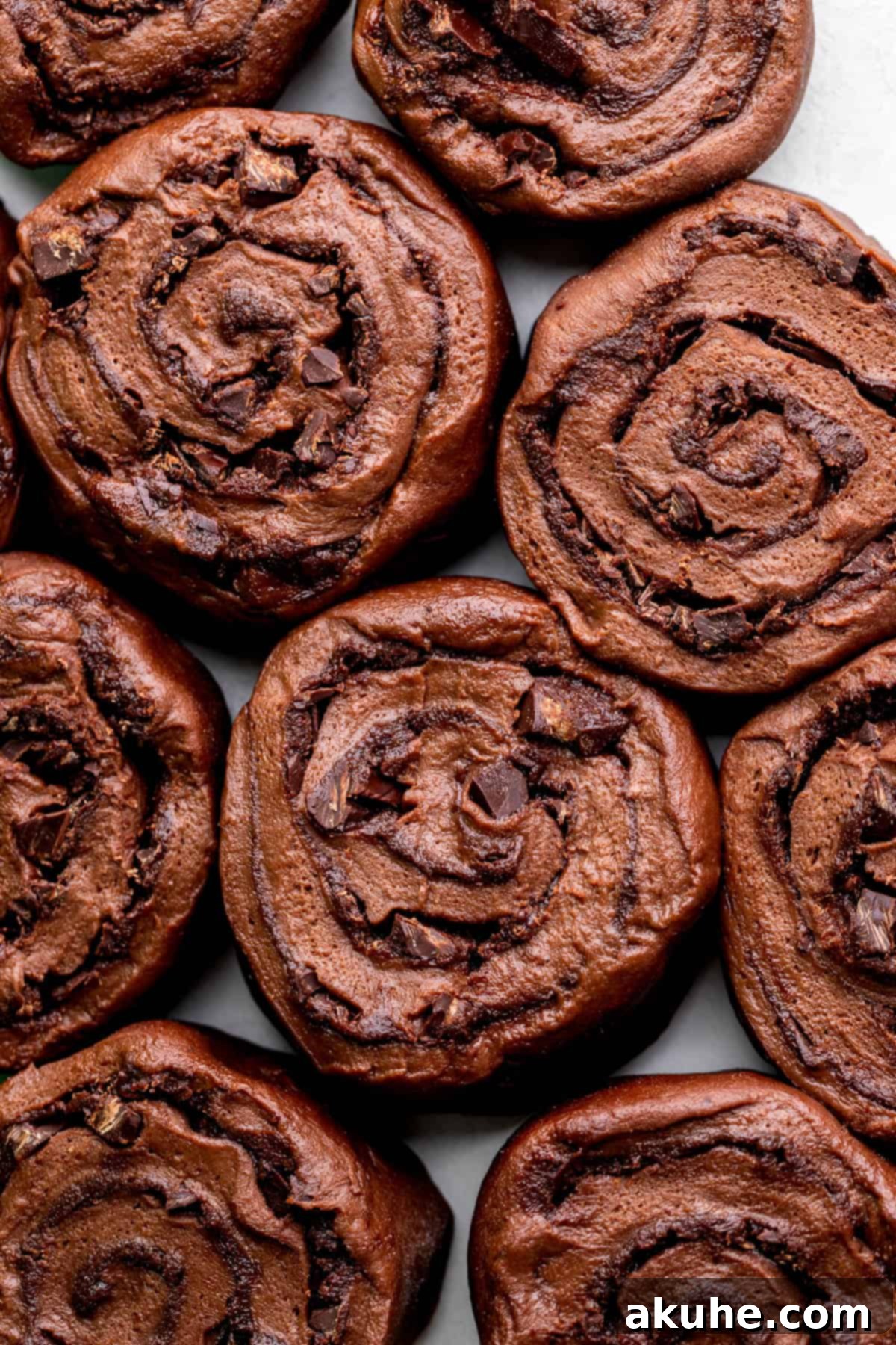 Decadent Chocolate Rolls 7 Raw chocolate rolls arranged in a baking pan, ready for the oven.