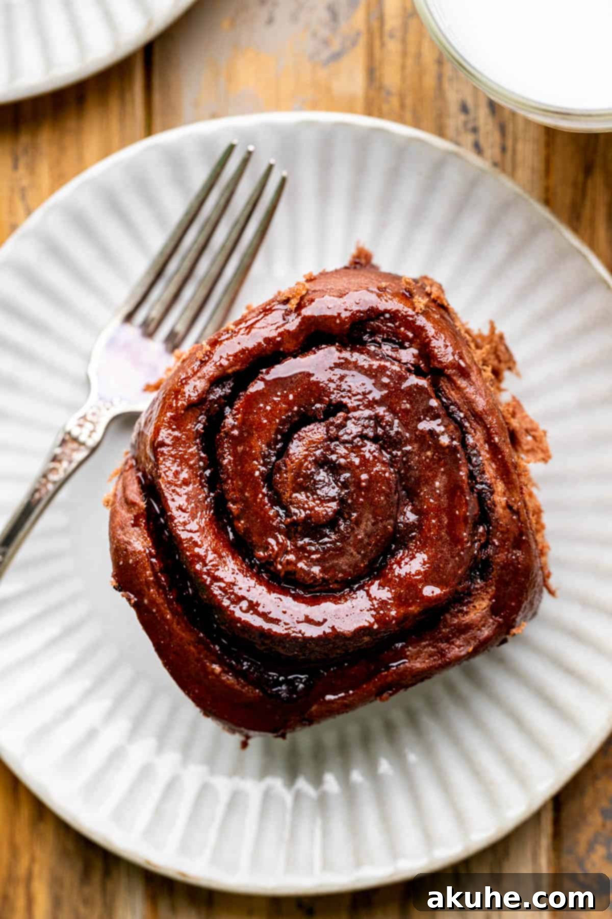 Decadent Chocolate Rolls 10 One perfectly iced chocolate roll resting on a white plate, ready to be enjoyed.