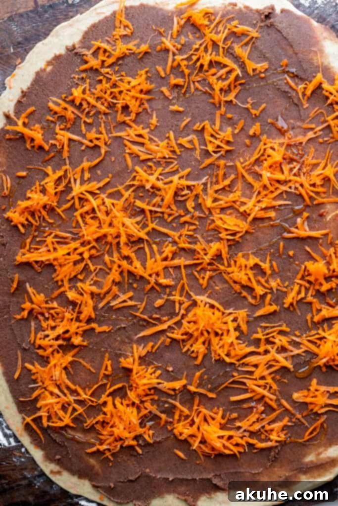 Carrot Cake Cinnamon Swirls 6 Cinnamon filling, grated carrots, and honey drizzled over the rolled-out dough.