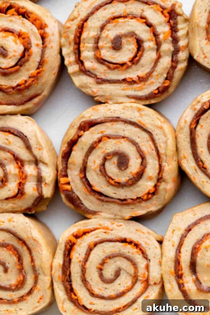 Carrot Cake Cinnamon Swirls 7 Rolled carrot cake dough, cut into 12 individual cinnamon rolls and placed in a baking pan.