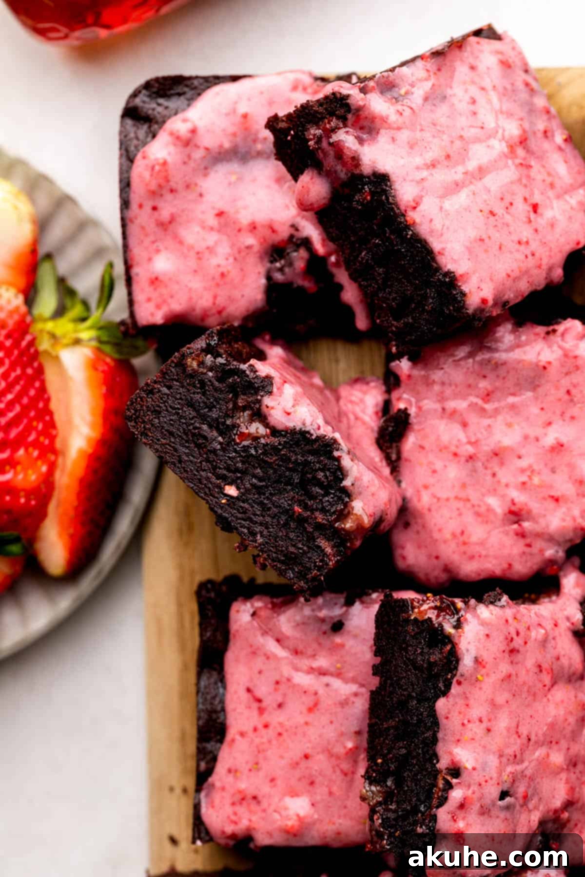 Decadent Strawberry Brownies 3 Close up of a strawberry brownie on a wood board.