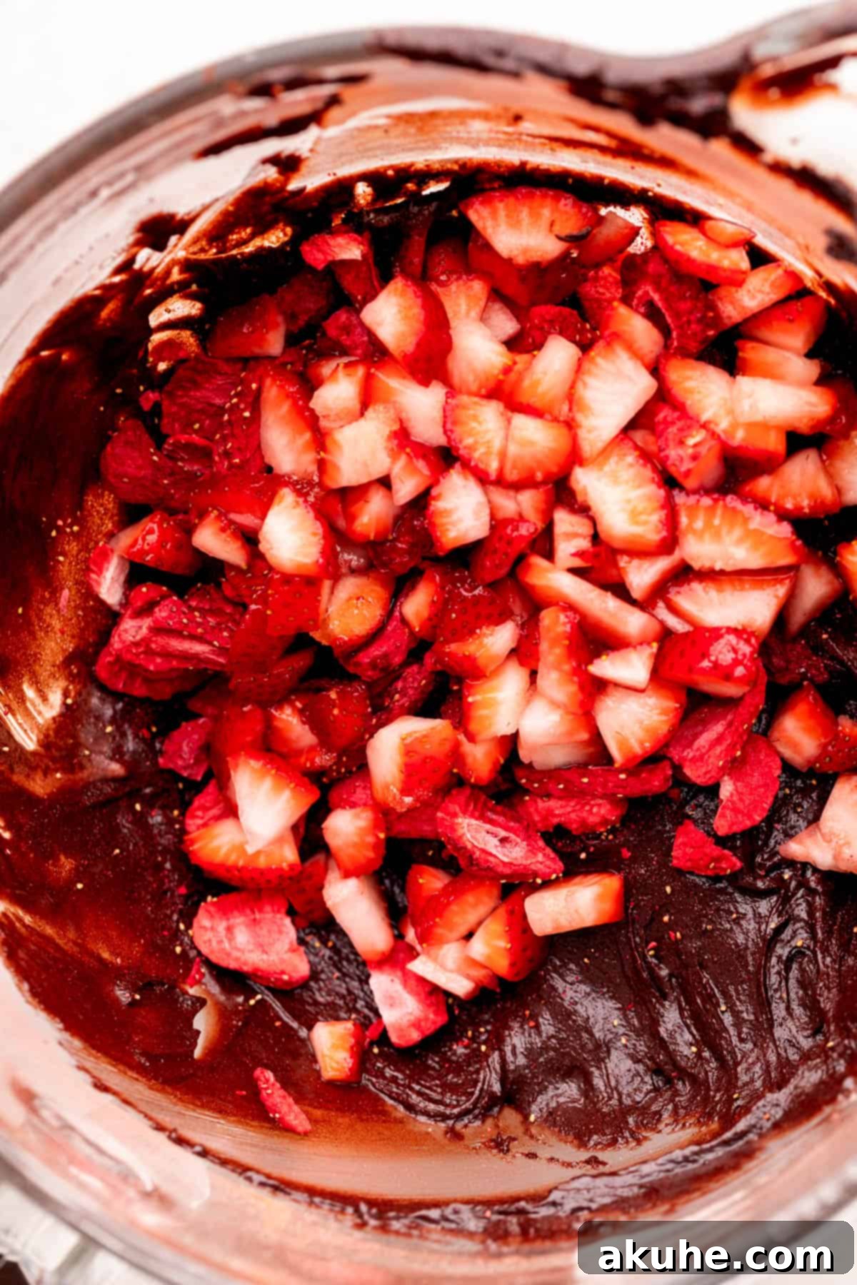Decadent Strawberry Brownies 6 Strawberries on top of the brownie batter.