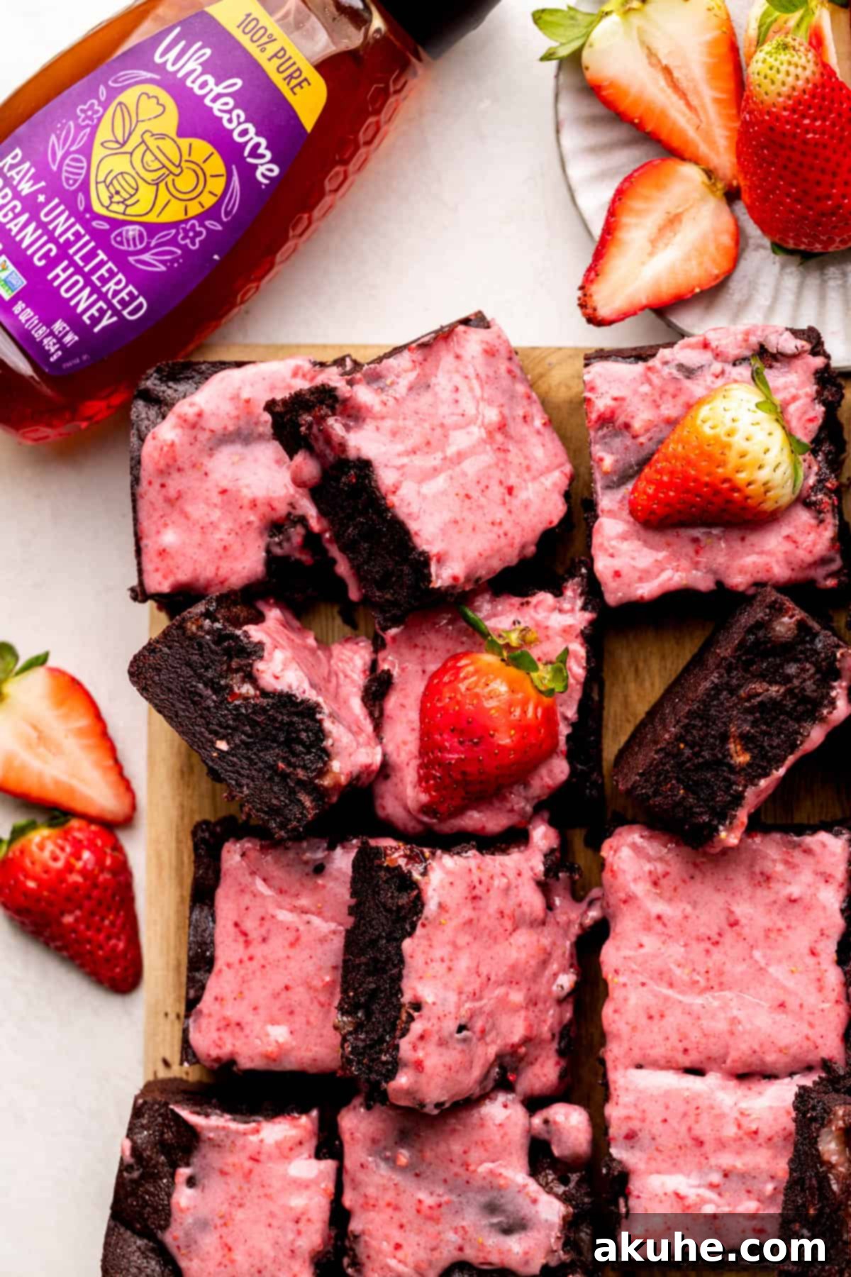 Decadent Strawberry Brownies 10 Strawberry brownies on a wood board.
