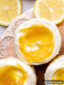Decorated lemon bar cupcakes on a wood board.