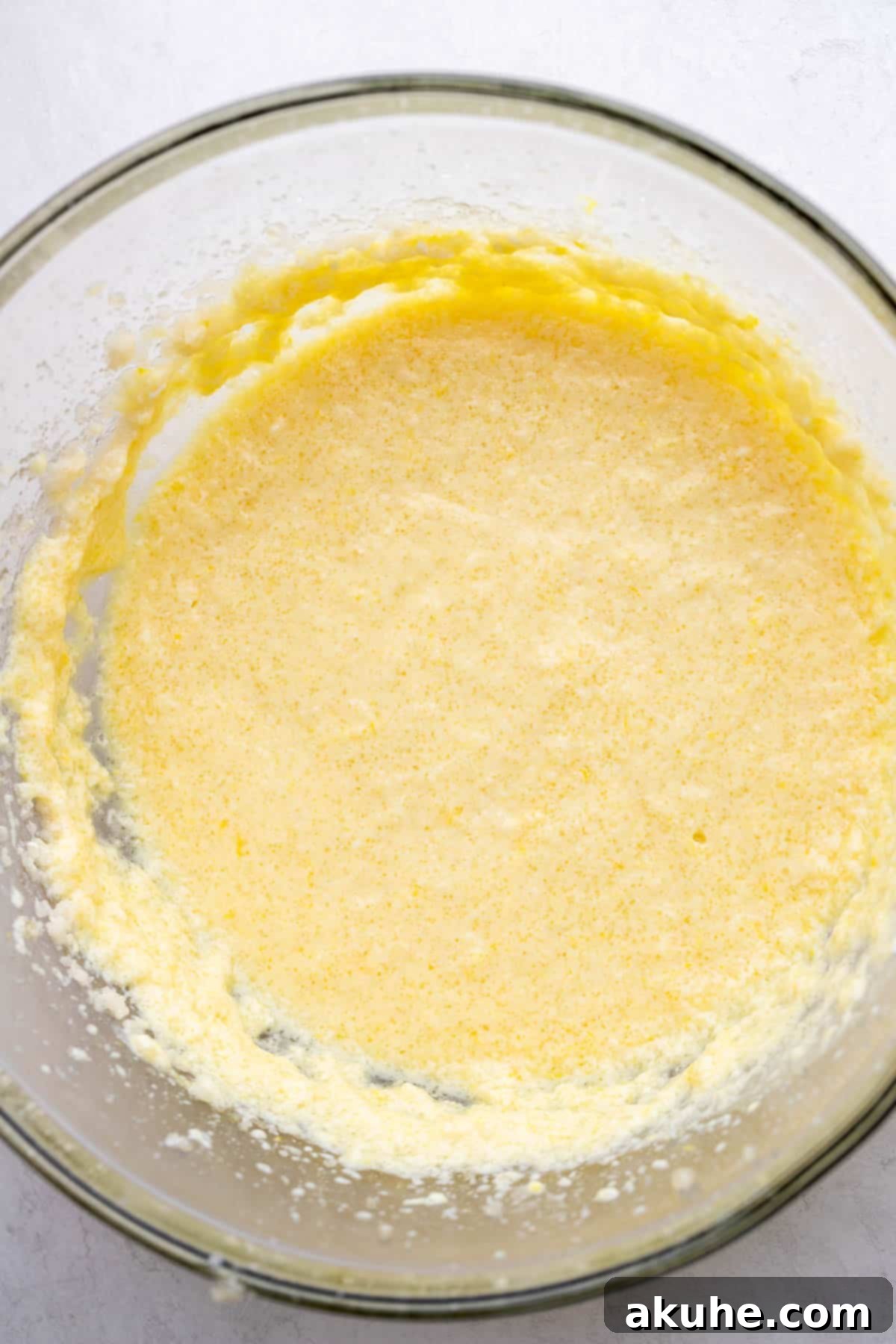 The combined wet ingredients for the lemon cupcake batter in a mixing bowl.