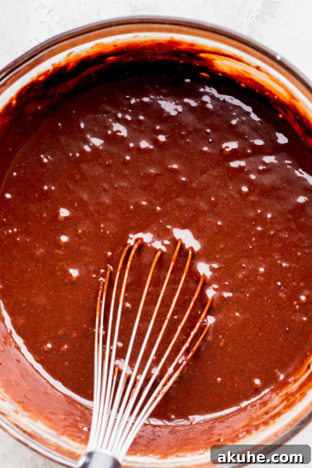 Creamy Chocolate Fudge Cake 5 Chocolate cake batter in a glass bowl.