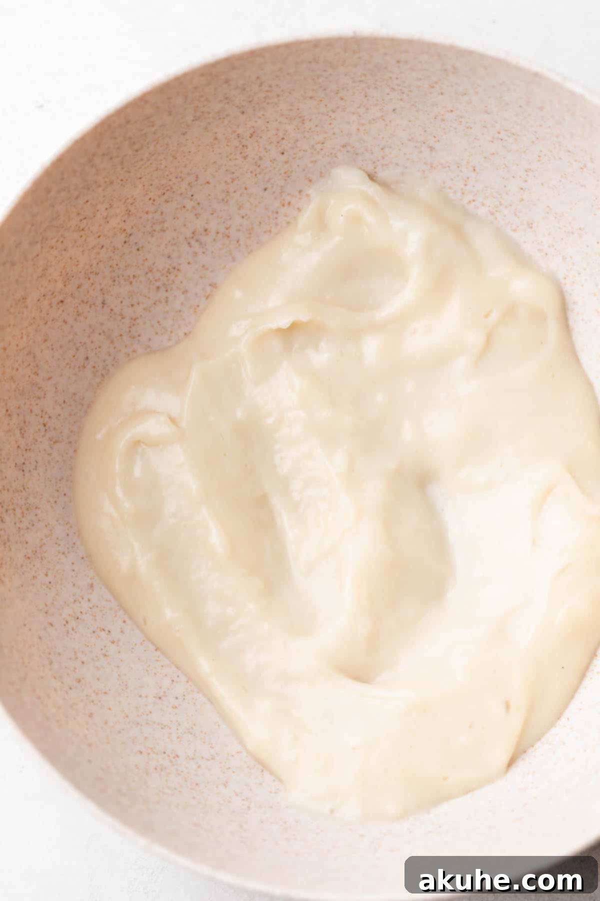 Creamy Chocolate Fudge Cake 7 Cooked milk in a bowl.