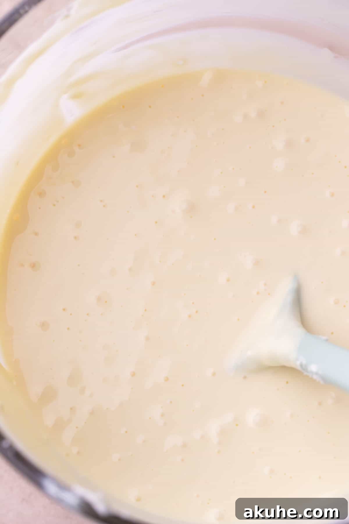 Decadent Gluten-Free Cheesecake 7 Smooth cheesecake batter in a glass bowl, perfectly mixed and ready for the pan.