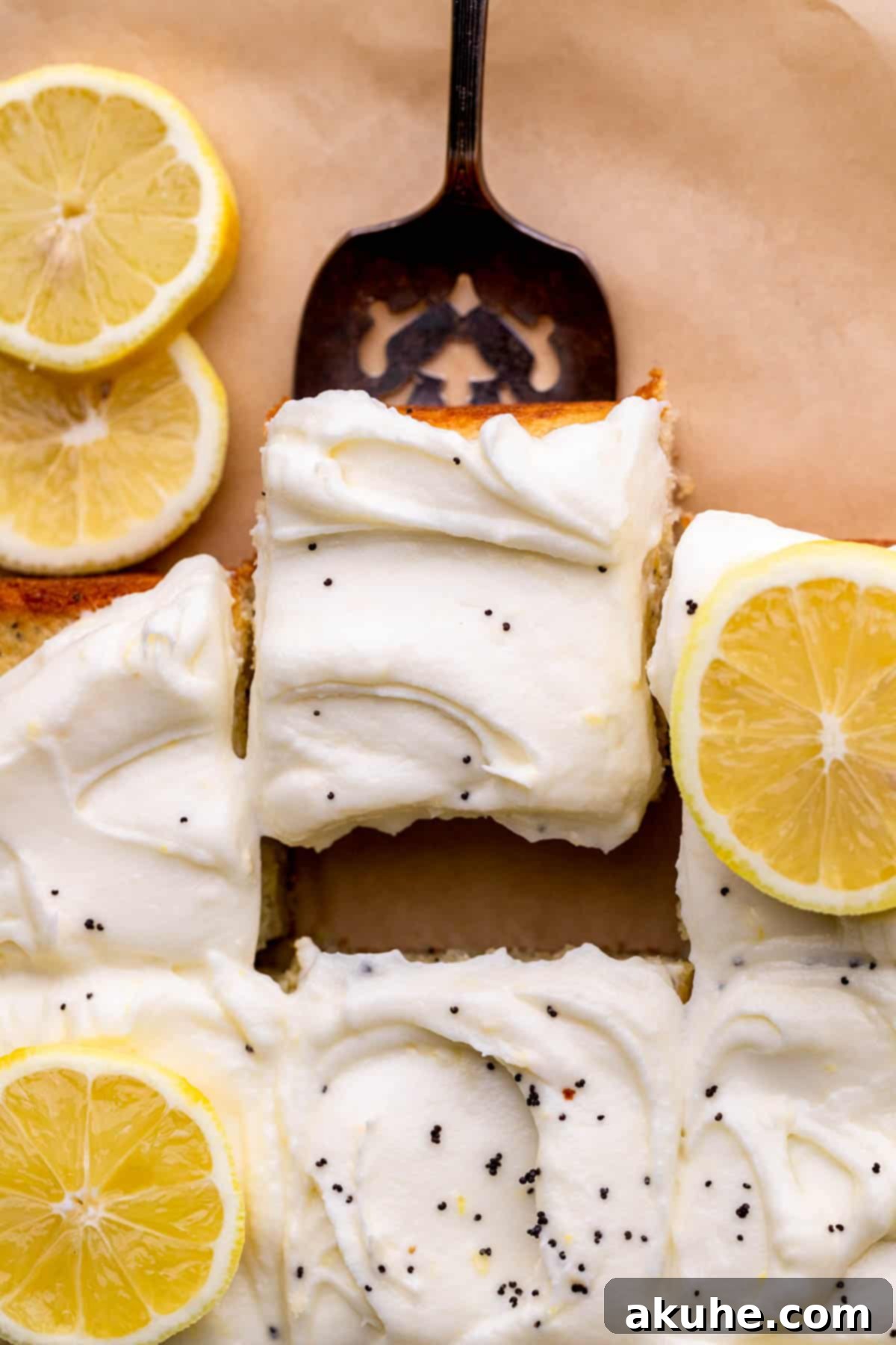 Bright Lemon Poppy Seed Cake 3 A baker's hand gently taking a slice out of a freshly baked Lemon Poppy Seed Cake, revealing its soft interior and luscious frosting.