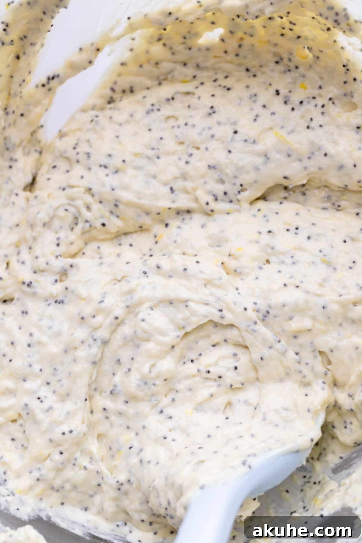 Bright Lemon Poppy Seed Cake 5 The fully mixed lemon poppy seed batter, with visible poppy seeds, ready to be poured into a baking pan.