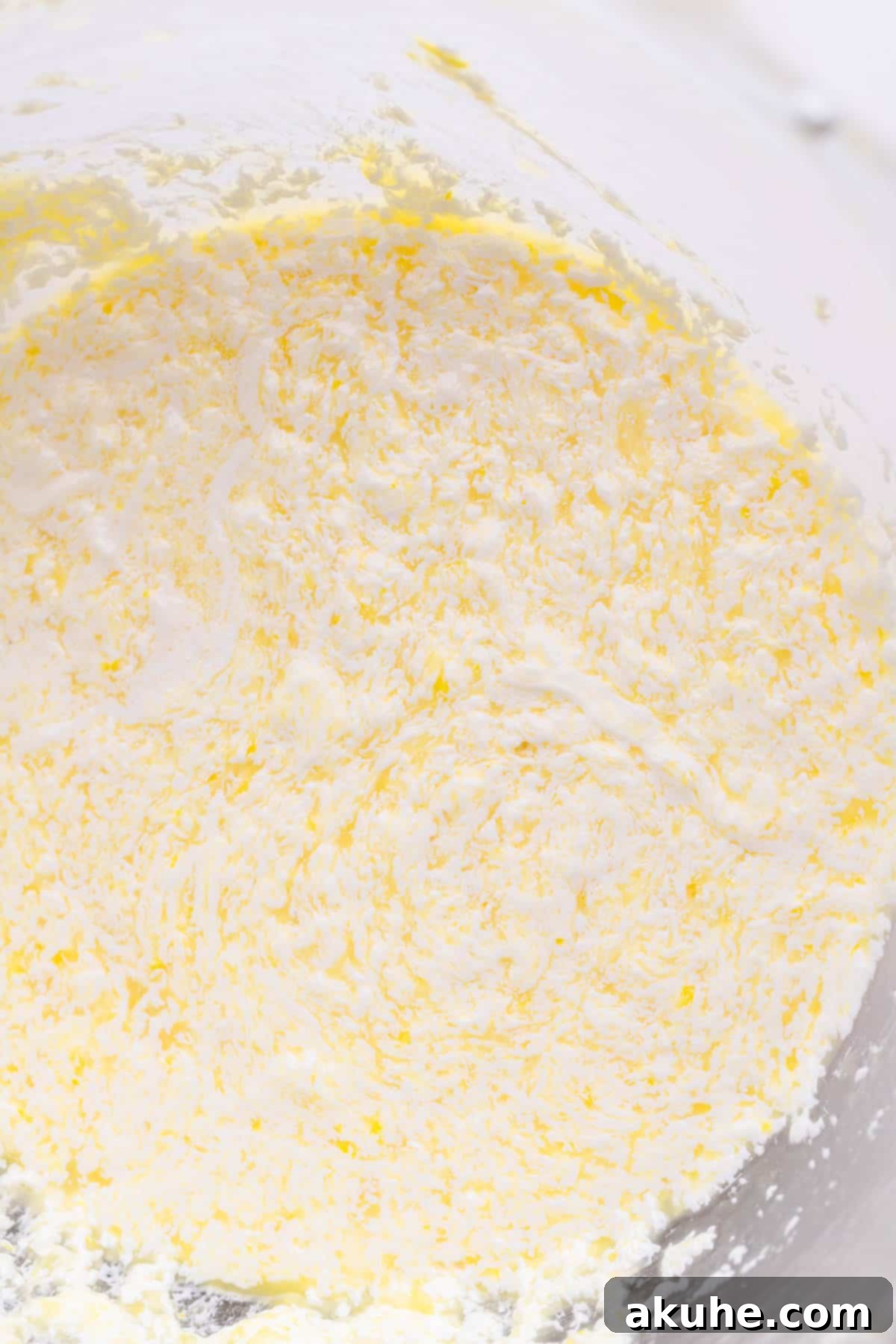 Wet ingredients for lemon cake batter in a mixing bowl.