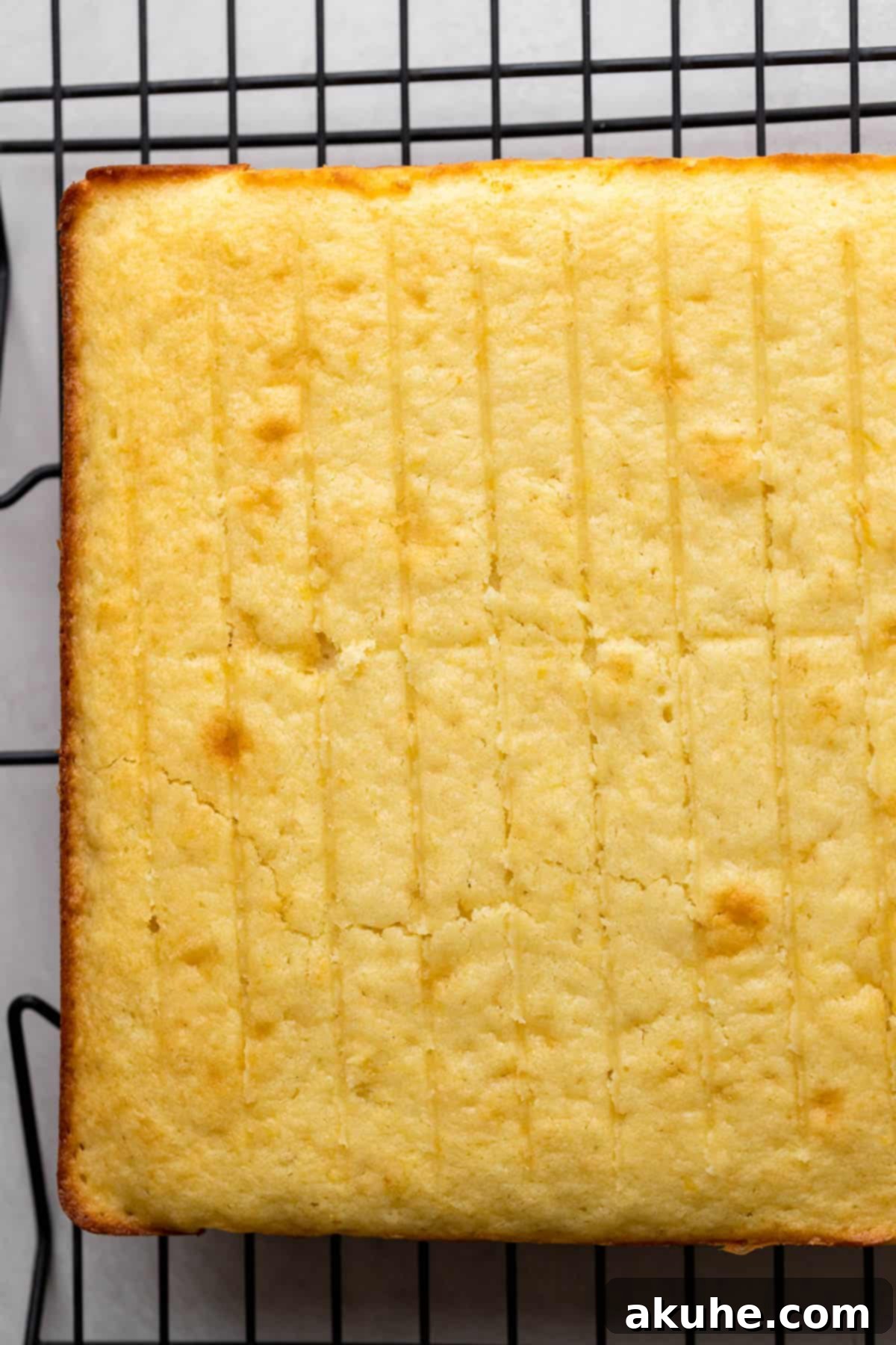 Freshly baked lemon cake cooling on a wire rack.