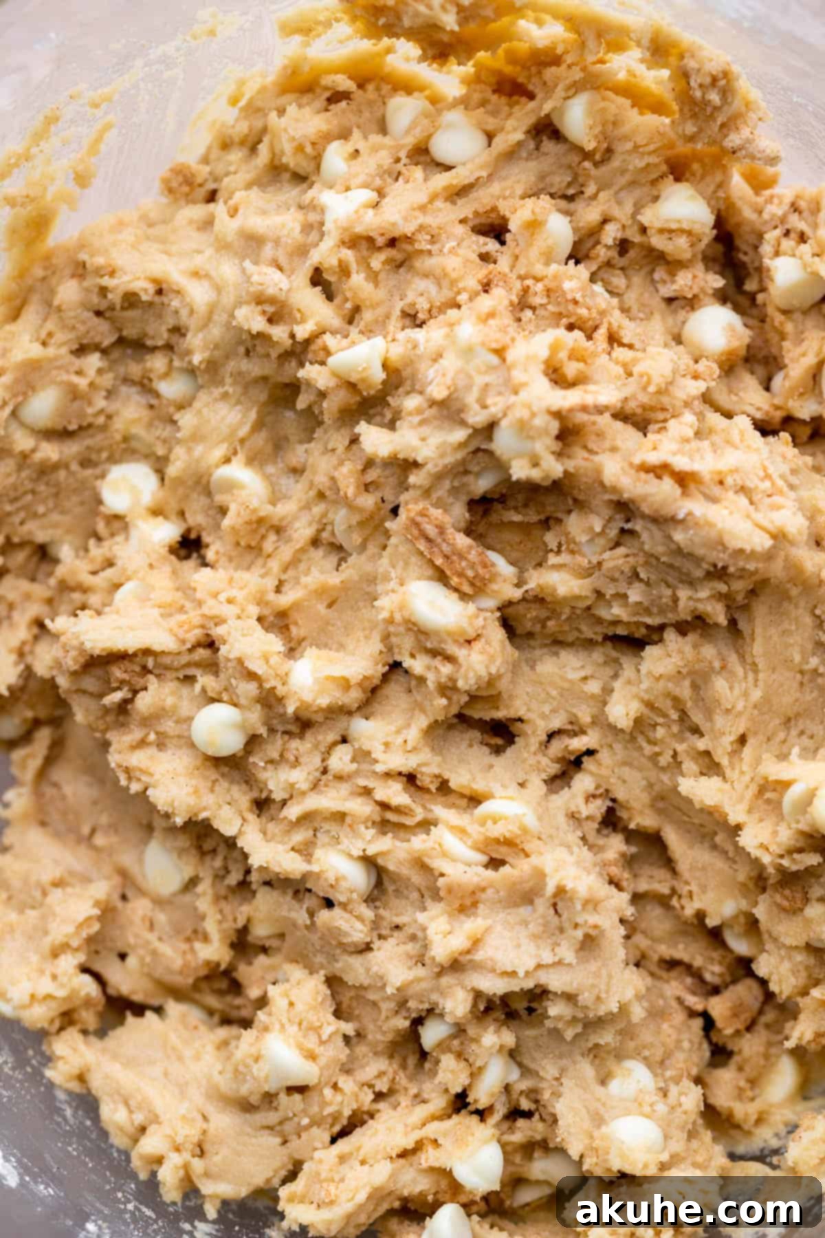 Crunchy Cinnamon Toast Cereal Cookies 6 Fully mixed cookie dough with inclusions in a glass bowl.