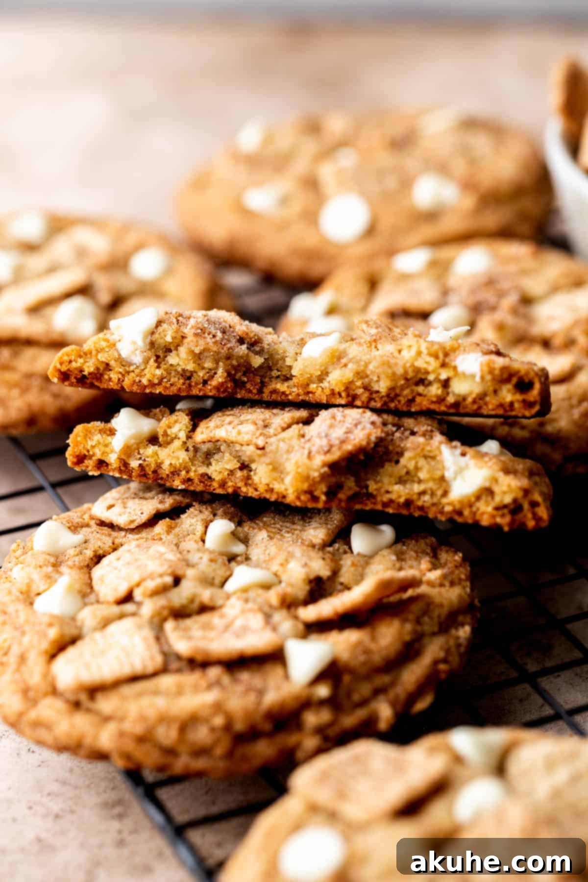 Crunchy Cinnamon Toast Cereal Cookies 9 A baked Cinnamon Toast Crunch cookie split in half, revealing its soft and chewy texture.