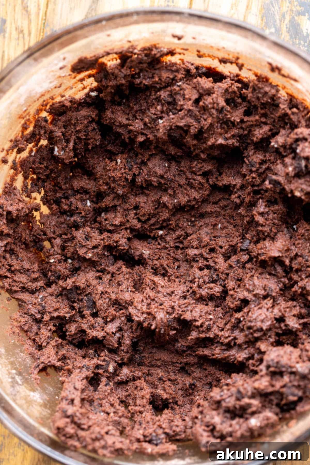 Chocolate cookie dough in a glass bowl.