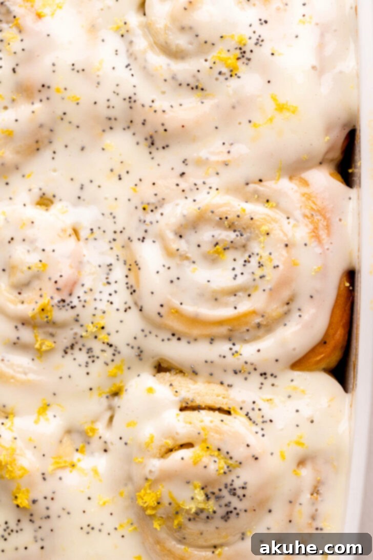 Sunshine Lemon Rolls 2 Top view of freshly baked lemon poppy seed rolls with lemon icing.