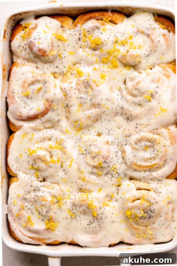 Sunshine Lemon Rolls 9 Top view of freshly iced lemon poppy seed rolls in a pan, ready to be served.