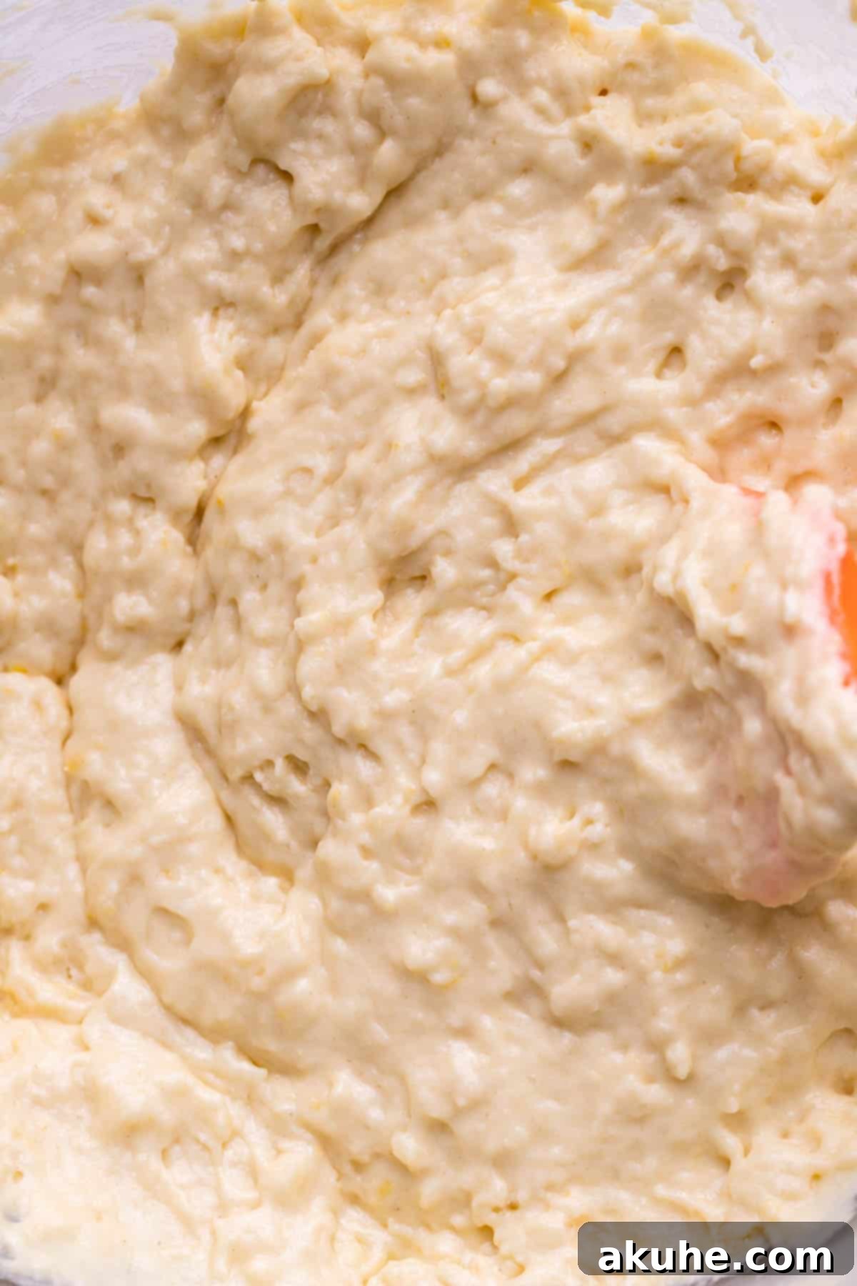 Zesty Lemon Donuts 5 Lemon donut batter in a glass bowl, showcasing its smooth consistency.