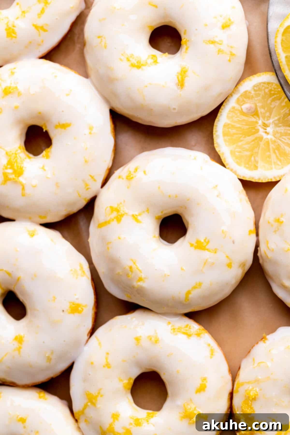 Zesty Lemon Donuts 8 A close-up top view of freshly glazed lemon donuts, garnished with extra lemon zest.