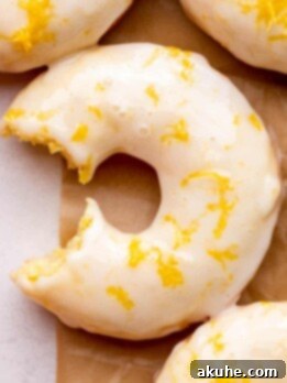 Zesty Lemon Donuts 10 One bite missing from lemon donuts.