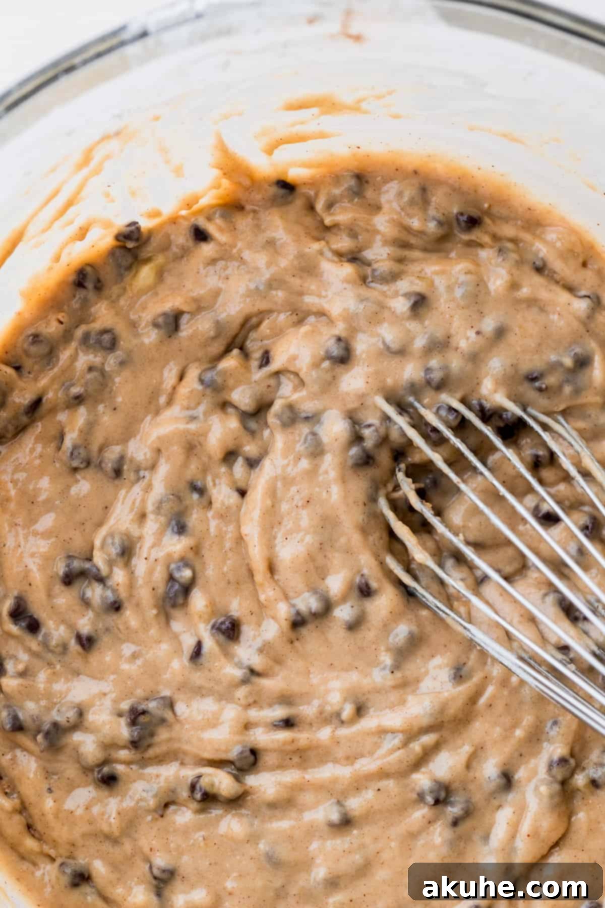 Cinnamon Swirl Chocolate Chip Banana Bread 6 Thick, rich banana bread batter with mini chocolate chips in a glass bowl.