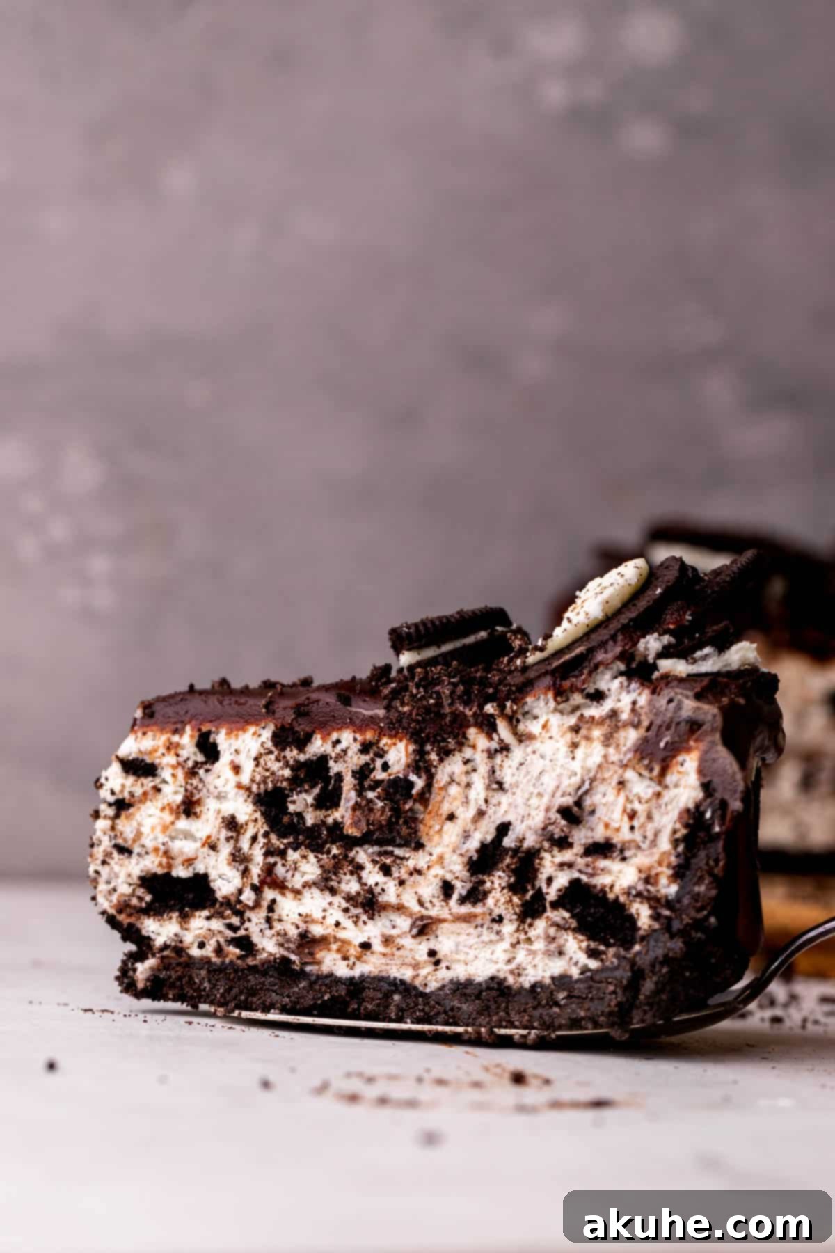One slice of no bake oreo cheesecake on a pie cutter.