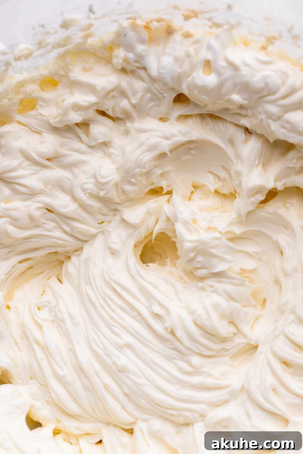 Whipped cream cheese in a glass bowl.