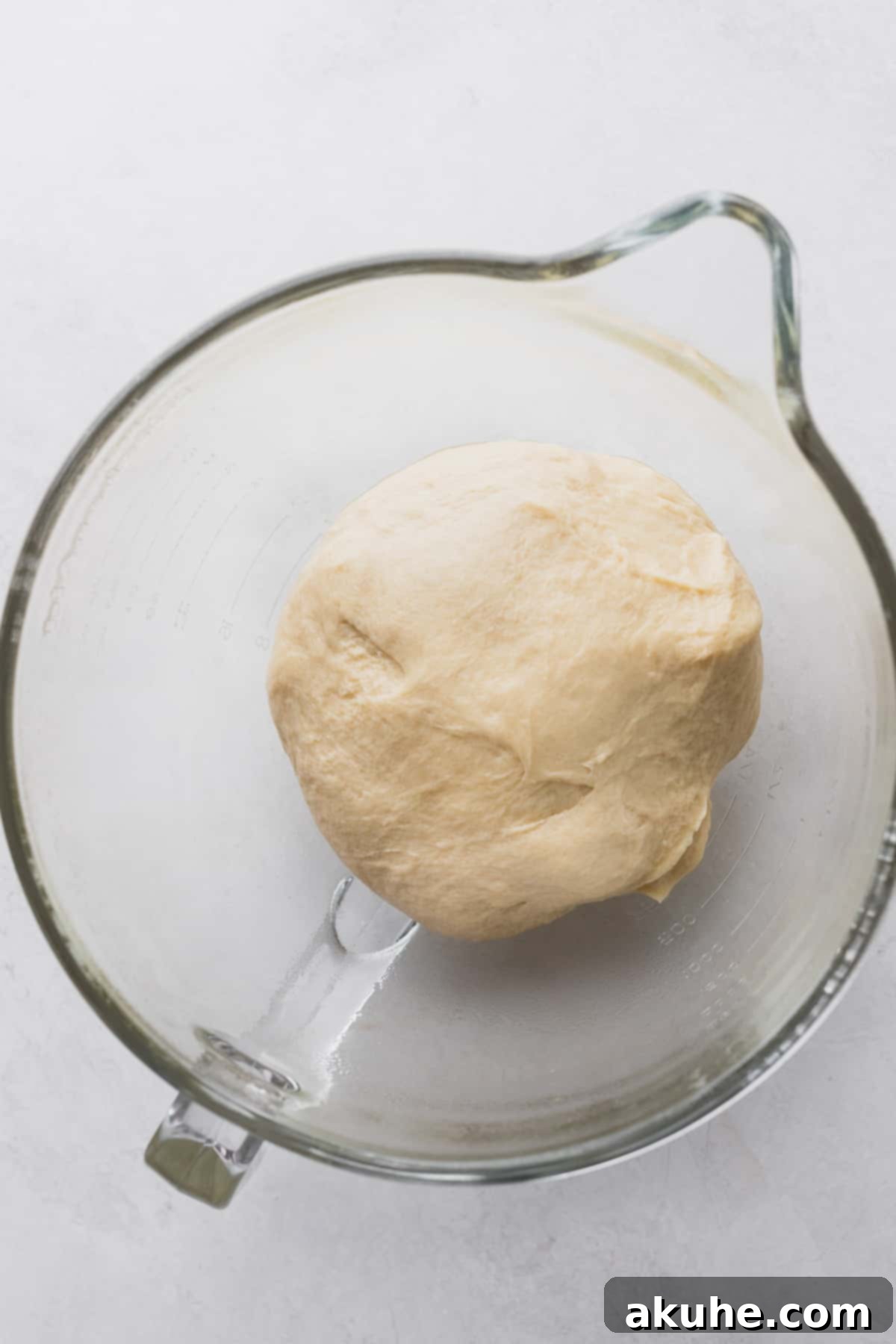 Gooey S'mores Cinnamon Buns 4 Dough in a glass bowl before its first rise, smooth and compact.