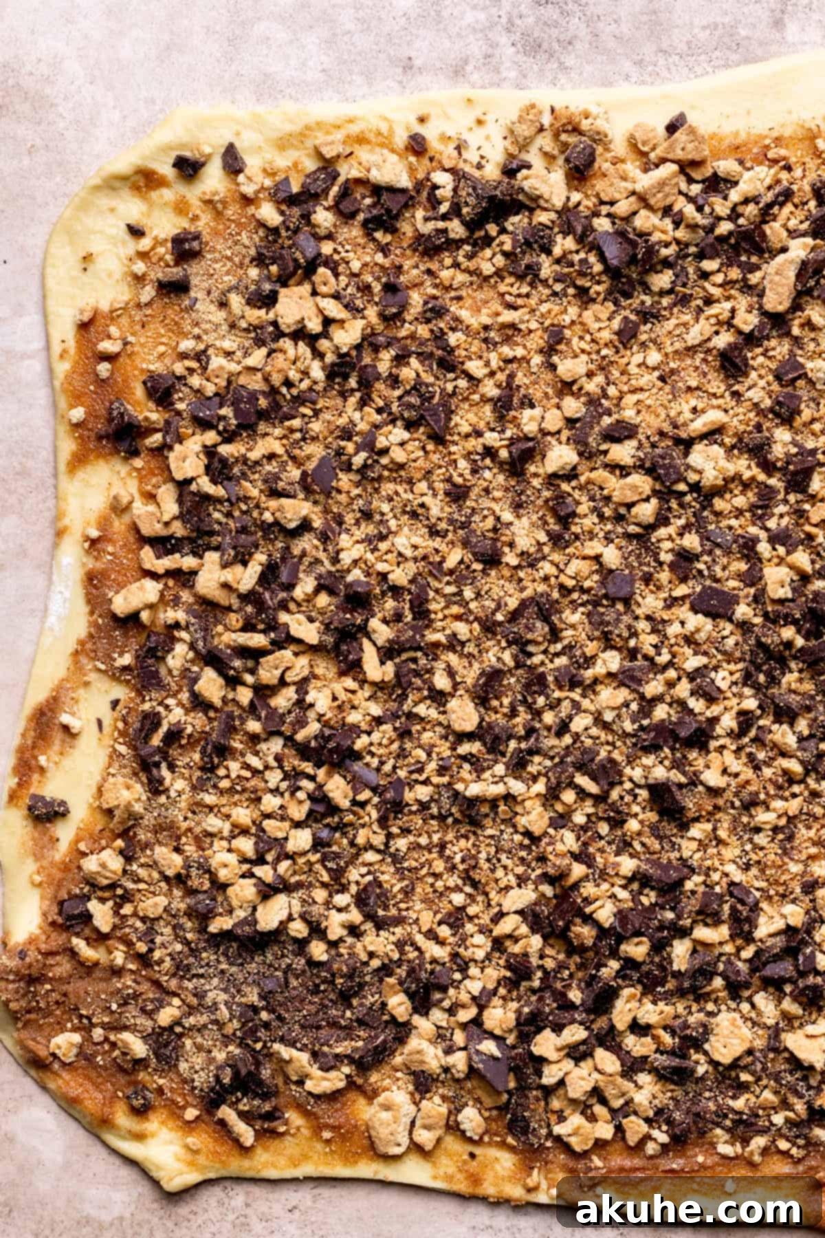 Gooey S'mores Cinnamon Buns 6 S'mores filling with chocolate and graham cracker crumbs spread over rolled dough.