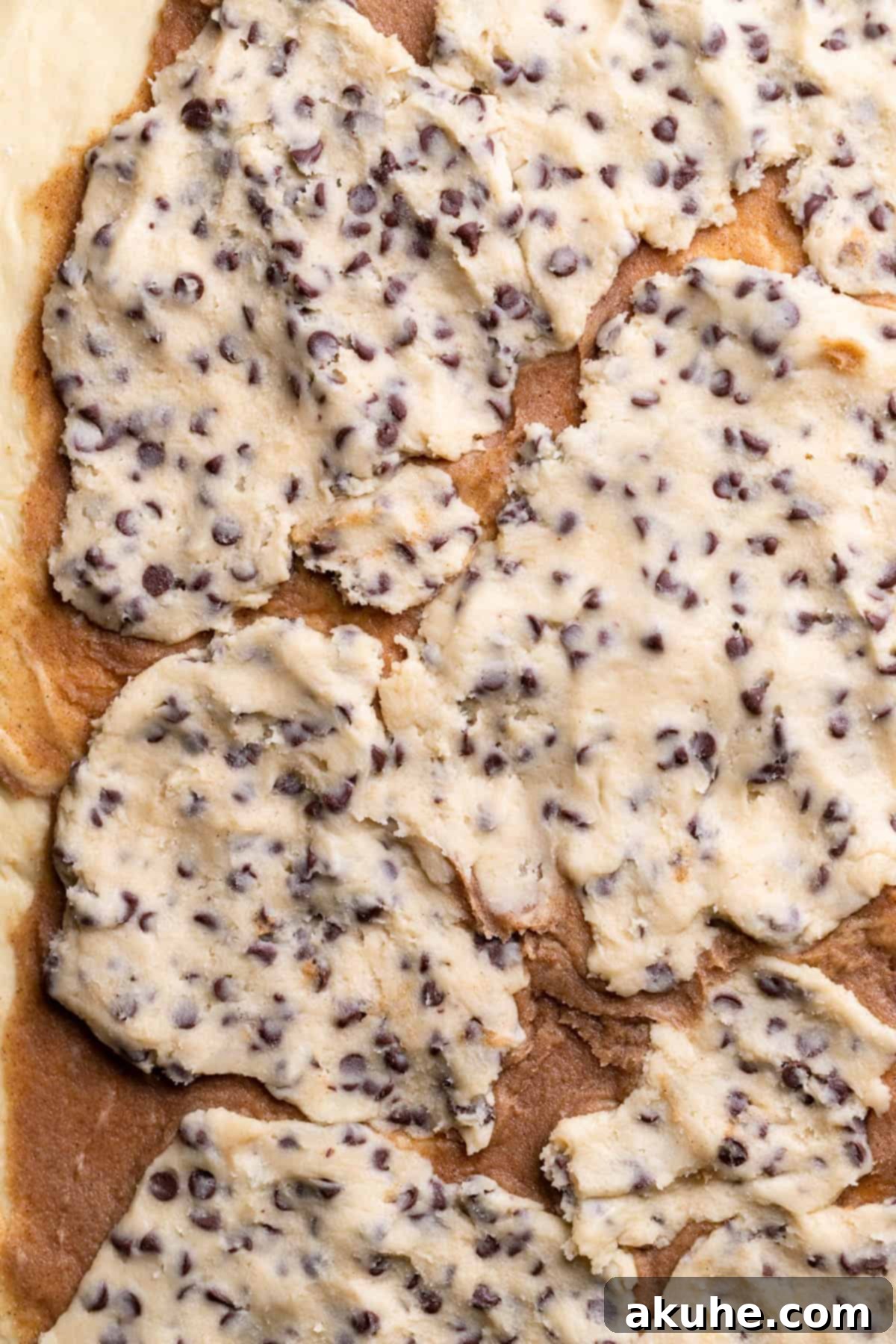 Cookie Dough Swirled Cinnamon Buns 7 Rolled dough with cinnamon filling and flattened cookie dough pieces.