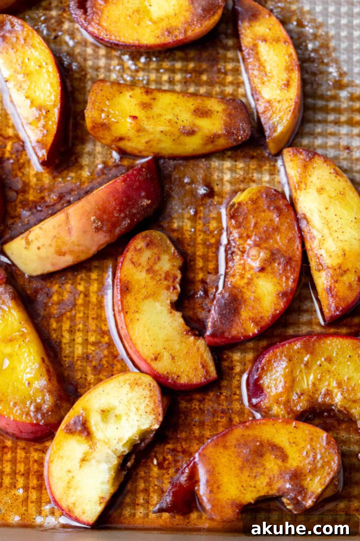 Sun-Kissed Peach Treats 5 Delicately sliced roasted peaches, glistening with caramelized sugars, laid out on a plate.