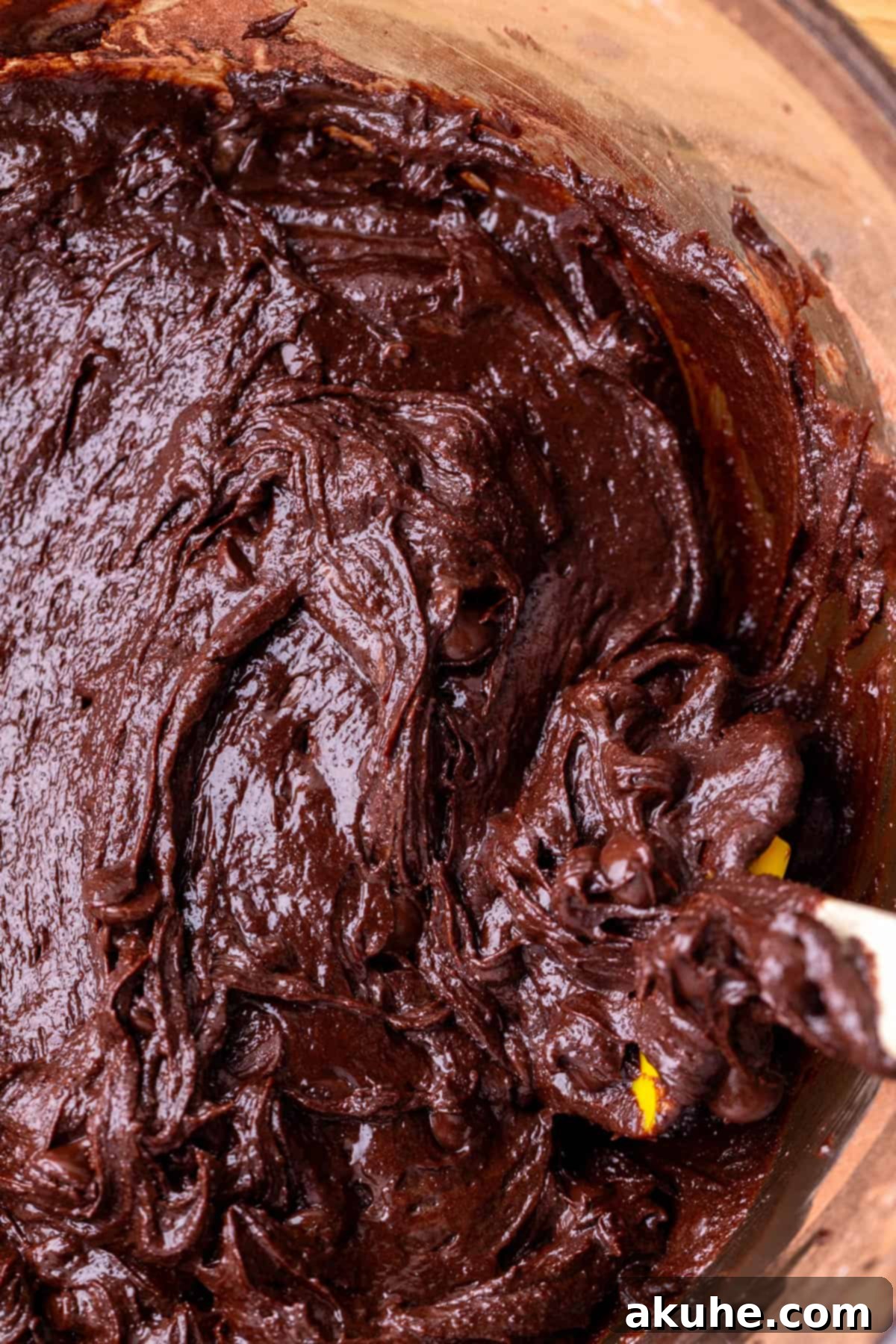 Decadent Cookie Dough Brownies 5 Rich chocolate brownie batter in a glass bowl, ready for baking.